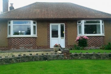 Dual white uPVC bay windows installation