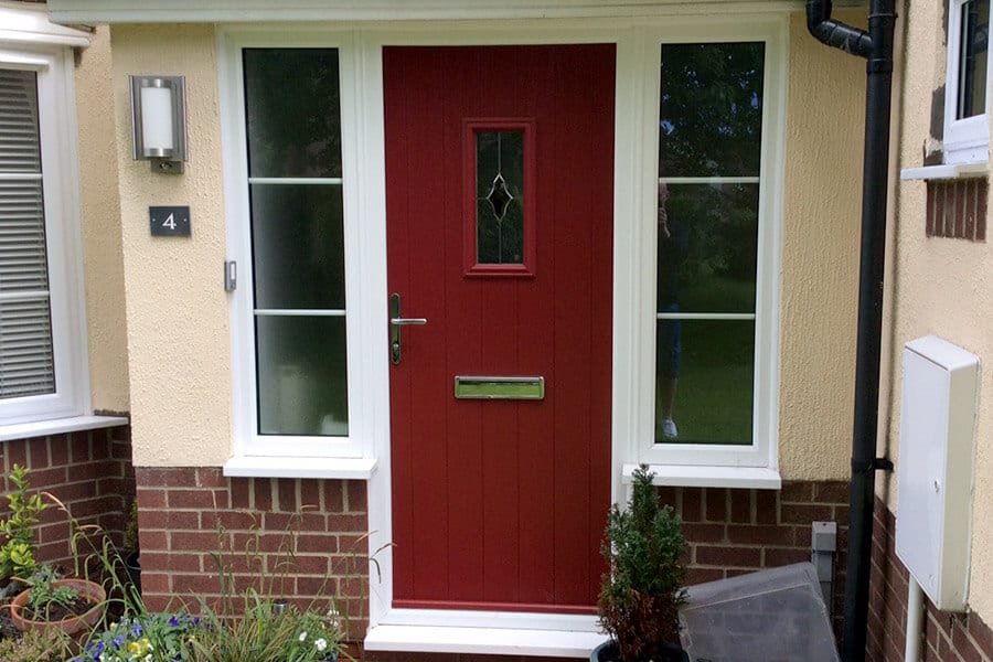 Red composite door with a white frame