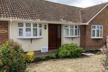 Dual white uPVC bow windows installation