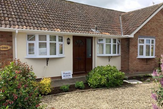Dual white uPVC bow windows installation