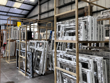 a shelf with different window and door frames stacked on them